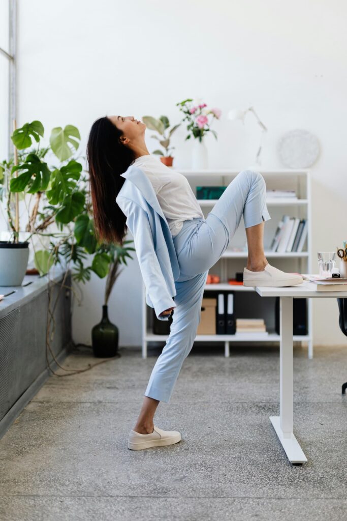 Person taking movement snack break with quick exercises during workday