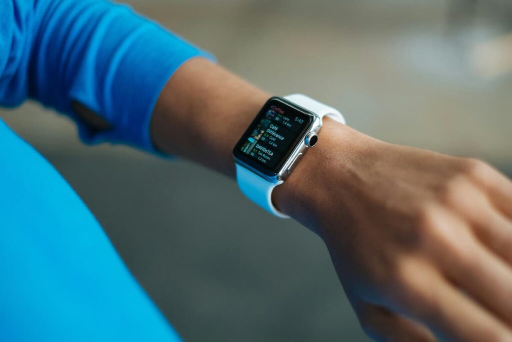 Person using wearable fitness tracker/smartwatch to monitor health data in 2026
